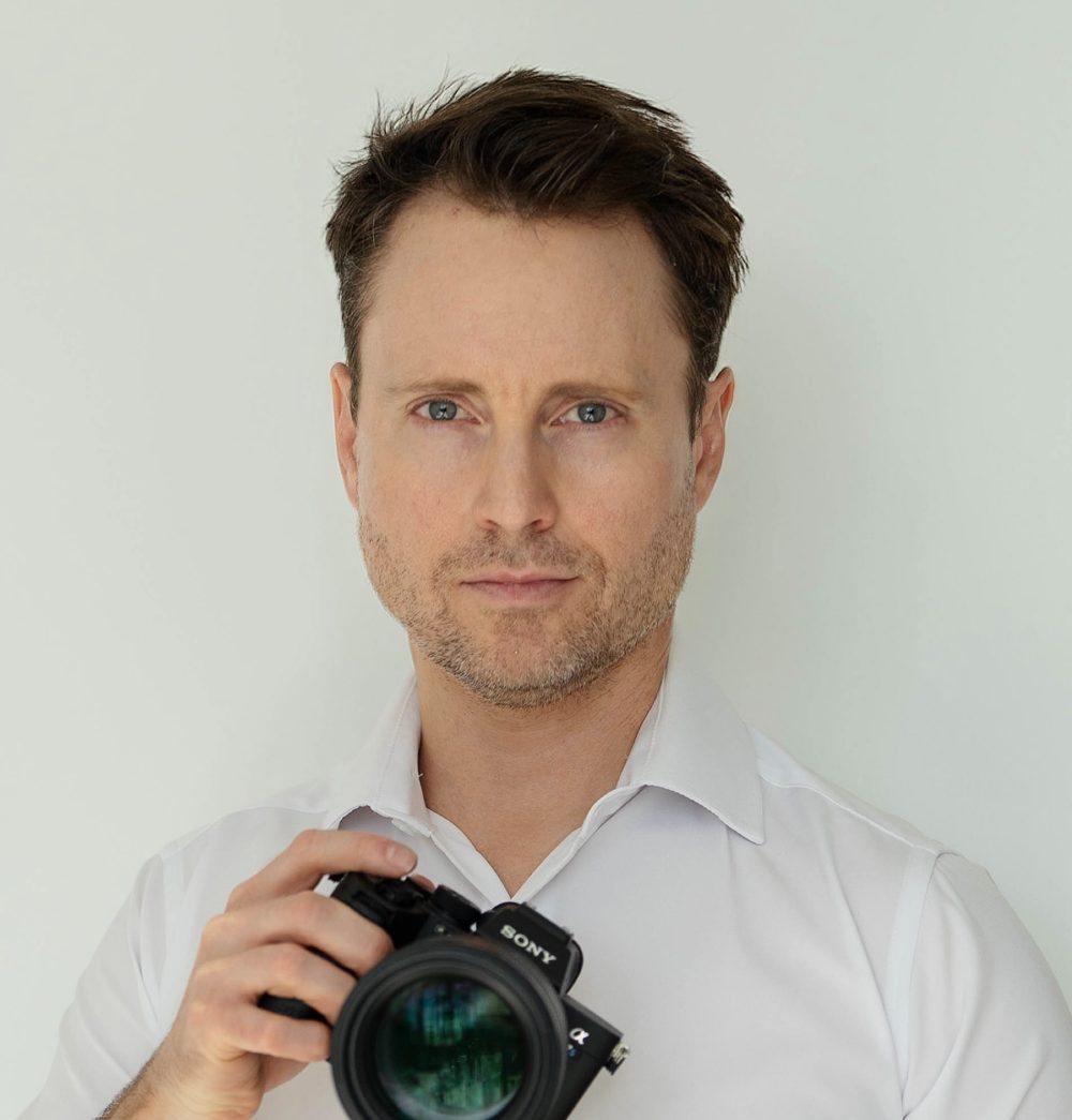 Sean, Scottsdale boudoir photographer, holding his camera